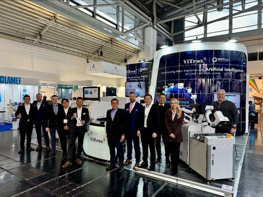 Group photo of ViTrox and MVTech teams proudly displaying the Global Technology Award 2023 trophy in front of the booth